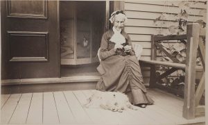 Photo of a woman seated next to a dog