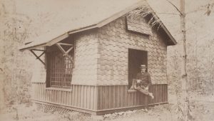 Photo of a man and dog in the window of a playhouse