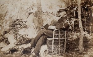 Photo of a seated man with a dog