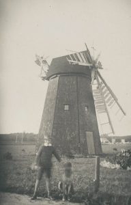 Photo of windmill with boy and dog