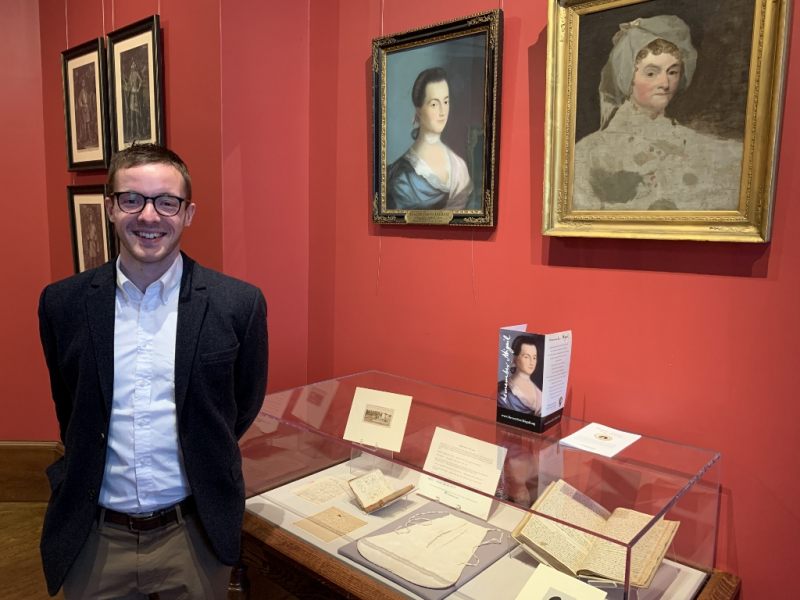 Man standing in front of exhibit case