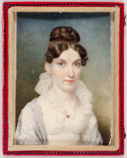 This is a bust-length portrait of a young, white woman gazing directly at the viewer, smiling softly. She wears a white dress with a lacy collar and a small, oval brooch in the middle, as well as a gold chain around her neck. Her long brown hair is held in place on top of her head with a comb and her curled bangs frame her forehead. The stippled background behind her fades from blue to green from top to bottom. The portrait is held in a red case.