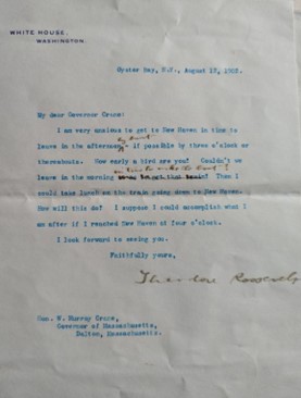 Color photograph of a blue ink typed letter with some black ink handwritten corrections and signature of Theodore Roosevelt. 