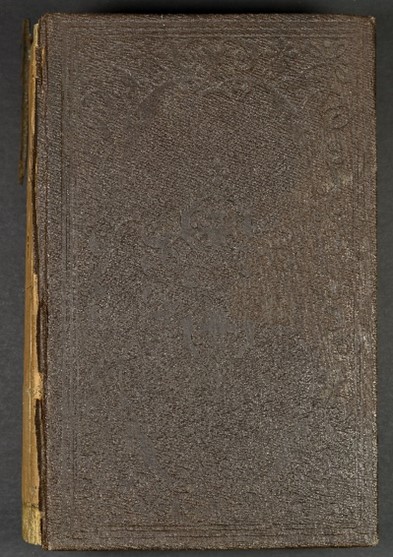 Brown leather book cover with imprints that are barely visible, an uncovered spin can be seen on the left. 