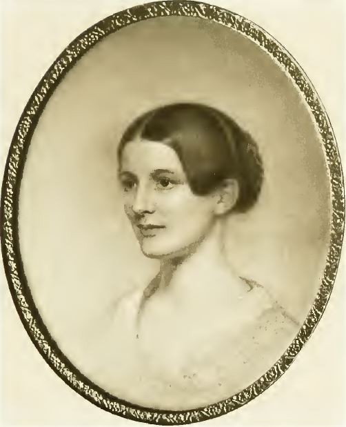 Black and white photograph of a painting in an oval frame depicting a young white woman looking to the side. The woman has brown hair pulled back into a braided bun.