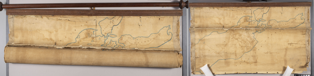 Left: Rolled map attached to a wooden rod.
Right: Unrolled map attached to a wood mount. Map has a crease down the center and is flaking at the edges.