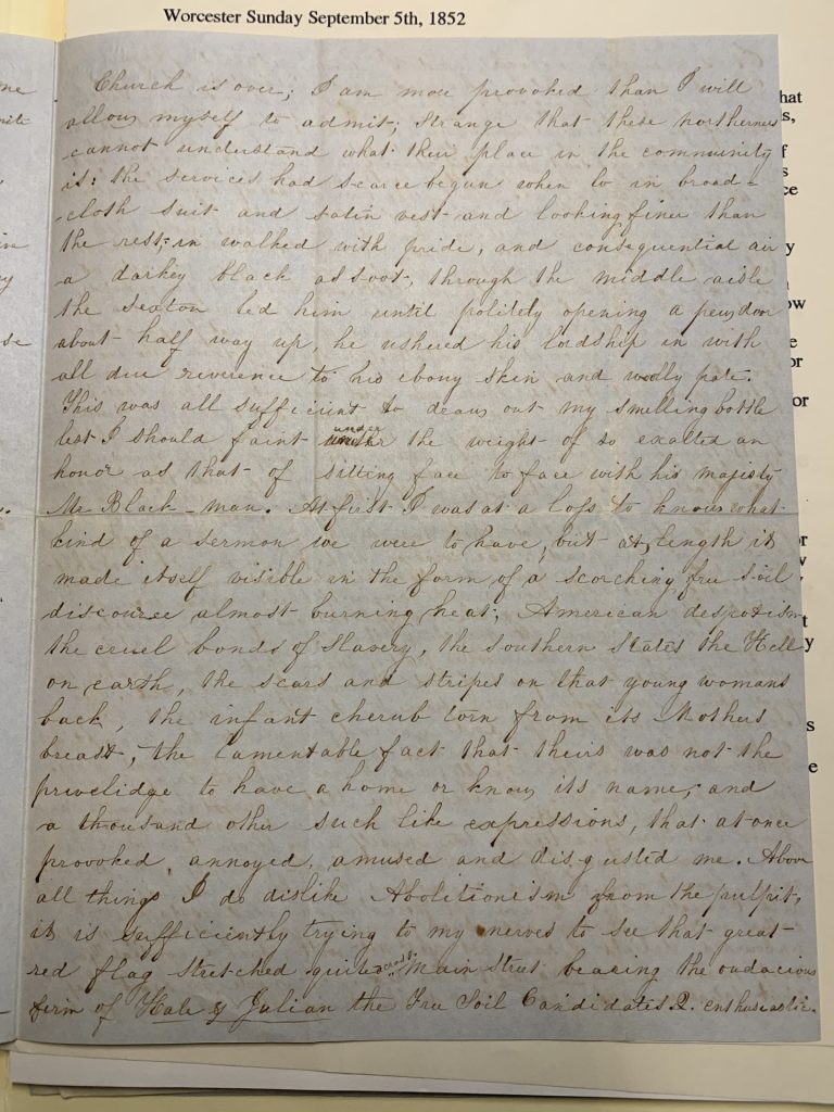 Color photograph of a black ink handwritten letter on paper discolored with age. 