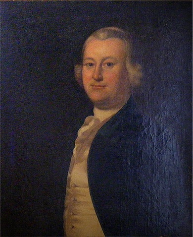 Color photograph of a painting of a middle-aged white man wearing a white wig, dark jacket, yellow vest and white cravat. The painting is very dark and no background can be seen. 