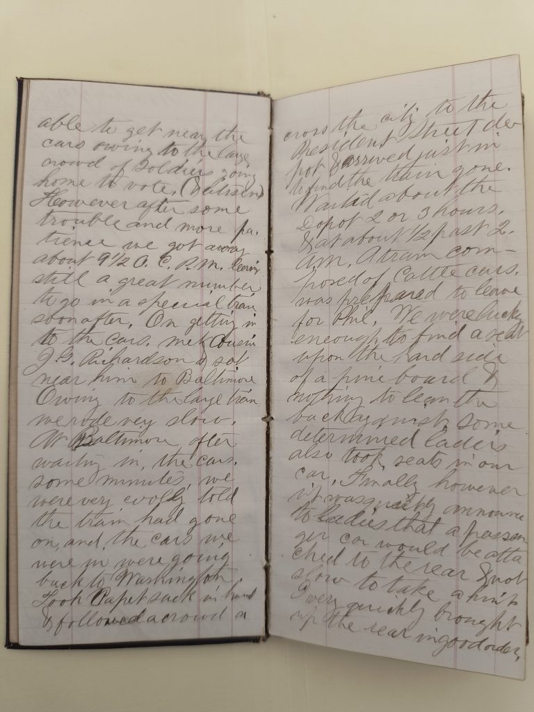 Color photograph of two open pages of a handwritten diary. The pages are lined, and entries are written on both sides in black ink.