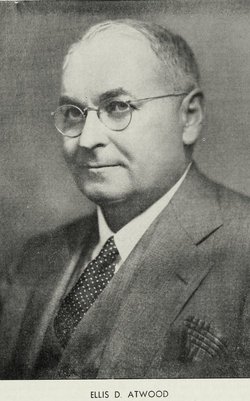 Black and white photograph of a white man with short gray hair and glasses, dressed in a suit and tie. A caption at the bottom reads: “Ellis D. Atwood.”