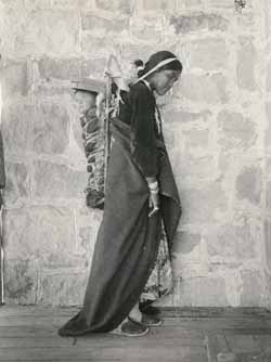 Unidentified woman carrying baby on her back Platinotype photograph