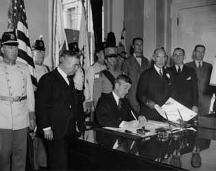 Massachusetts Governor Leverett Saltonstall signing the US Bill of of Rights, 3 March 1939 Photograph