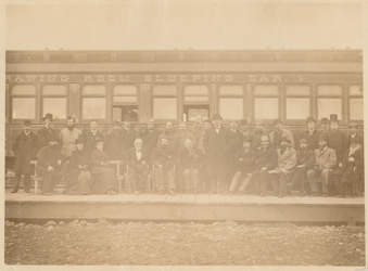 Group in front of a train car Photograph