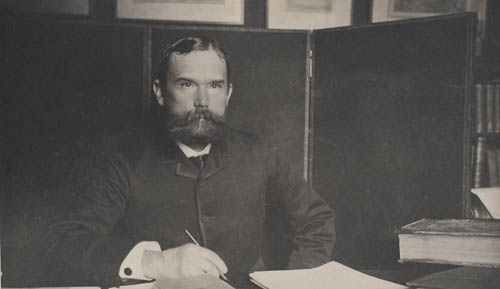 John Hay writing at desk Photograph