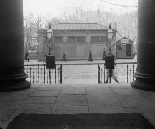 View of subway entrance at corner of Park and Tremont Streets from steps of St. Paul`s Cathedral, Boston Lantern slide