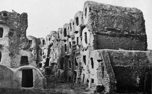 Glimpses of one of the world`s queerest apartment buildings: the natives in Adobe houses that resemble the nests of mud wasps... Lantern slide