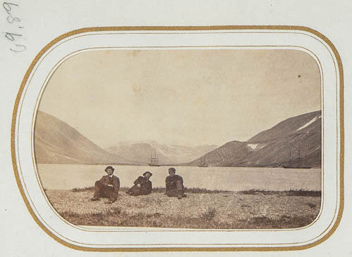 View of three unidentified men near lake, ships and mountains in background Carte de visite