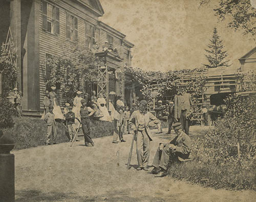 Students in front of Nathaniel T. Allen`s house, some with baseball bats Photograph