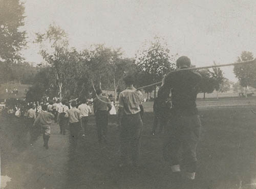 `Rope pull across pond,` Class of 1910 vs. Class of 1909 Photograph