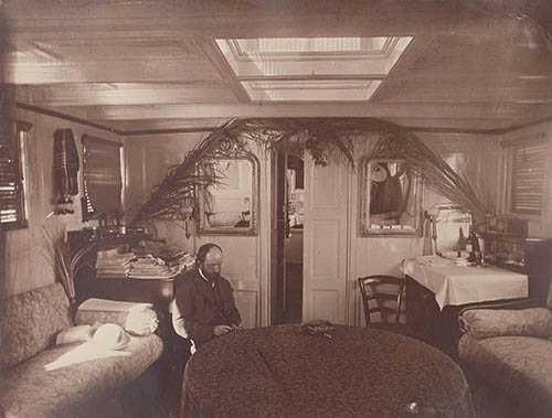 View of Henry Adams (seated) in a cabin in the dahabeah, Isis Photograph