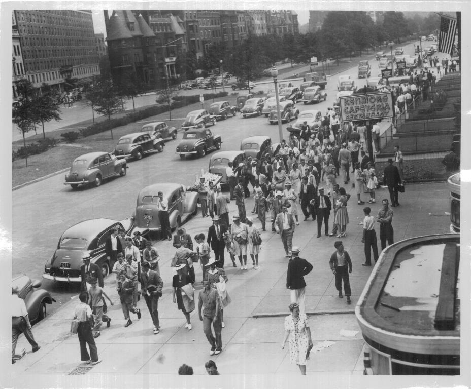 A crowd of pedestrians walking on Comm Ave in Kenmore Square, spring circa 1944